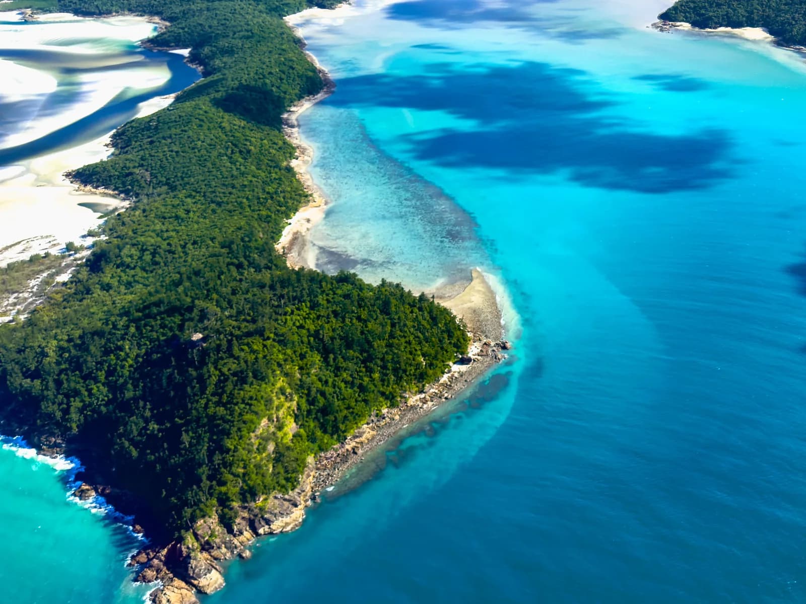 Aerial view of Hill Inlet and Whitehaven Beach in the Whitsundays, with white sand swirling through turquoise water.